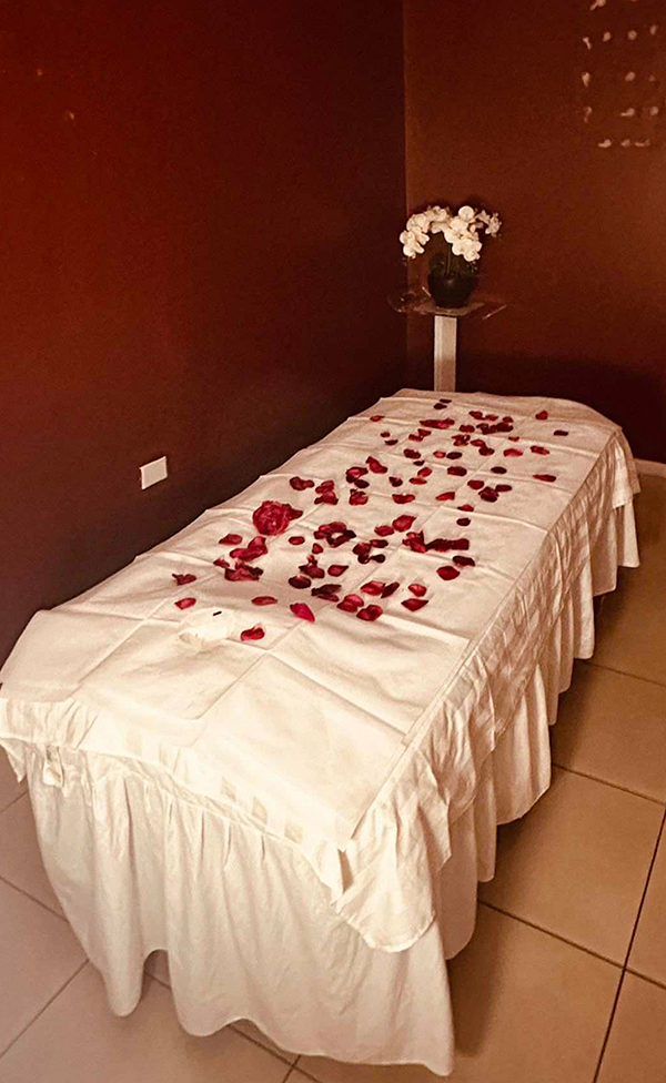Private Burwood massage room with cream linens and rose petals